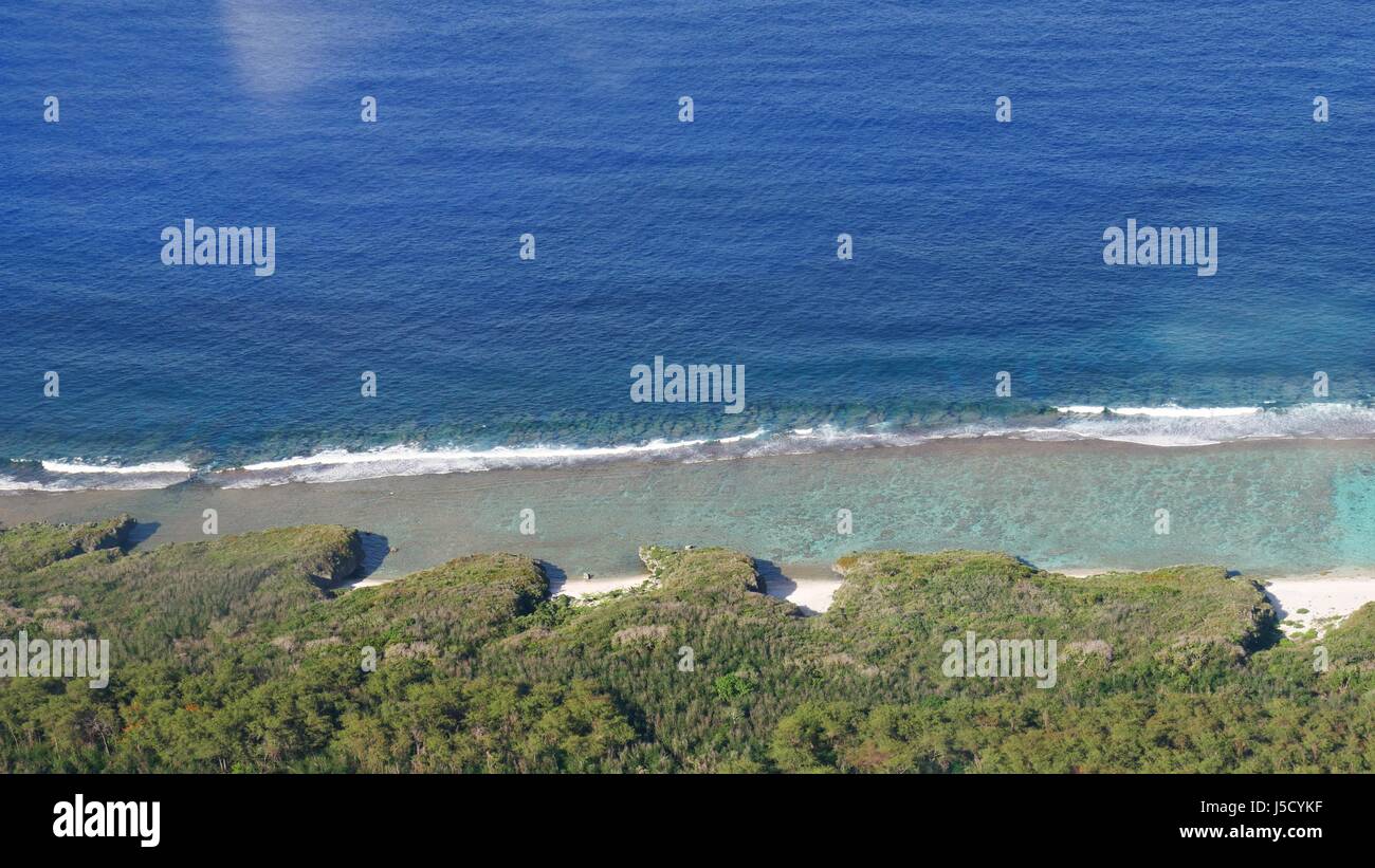 Aerial view of the gorgeous cliffs and coves of Tinian coastlines Stock Photo