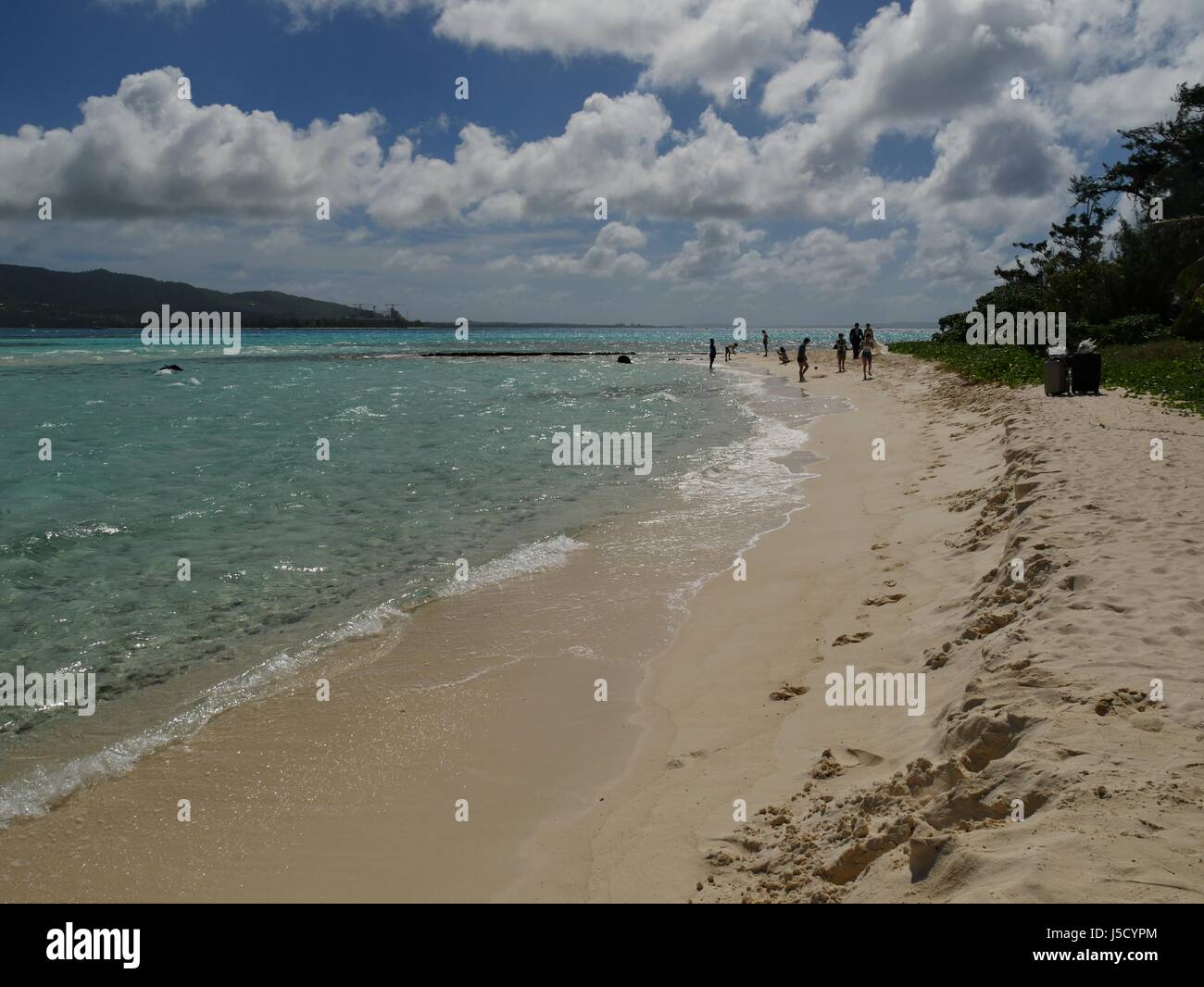 Saipan, USA- October 2016: Gentle waves roll into the white sandy beaches of Managaha Island Stock Photo