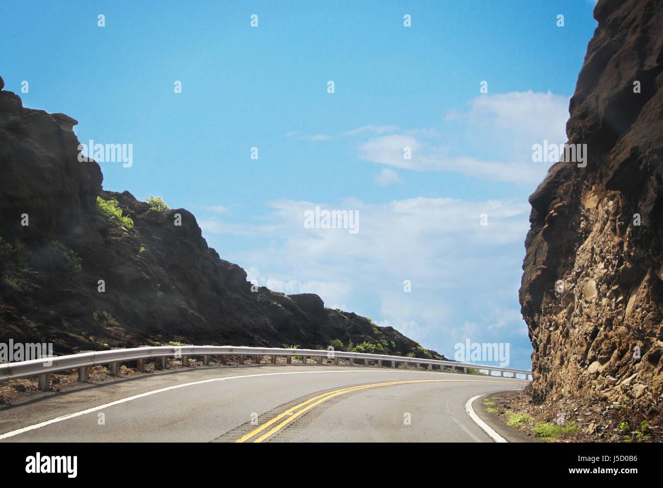Driving through the breathtaking cliffs and twists of Oahu roads, Hawaii Stock Photo