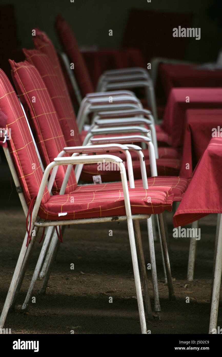 cafe chairs tables seats table cloth chequered vacant becomes an orphan empty Stock Photo