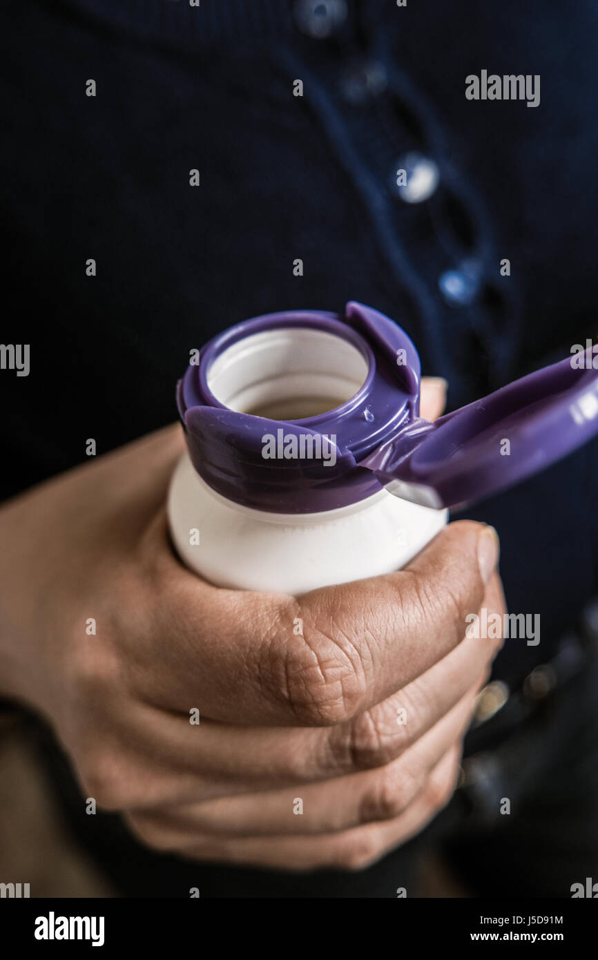 Opening a medicine bottle. Pill box open lid in womens hand Stock Photo