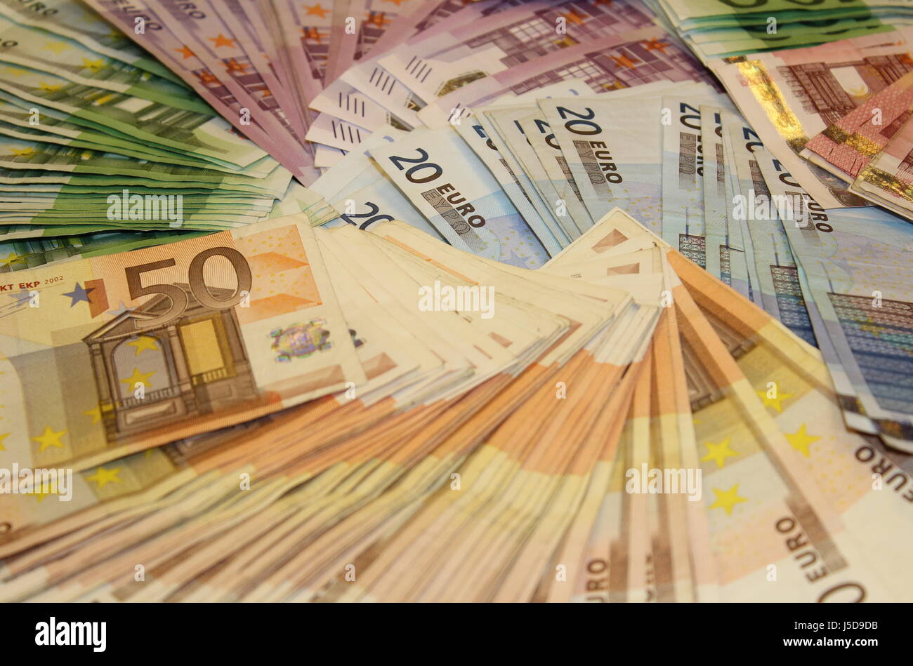 Pile of money Stock Photo - Alamy