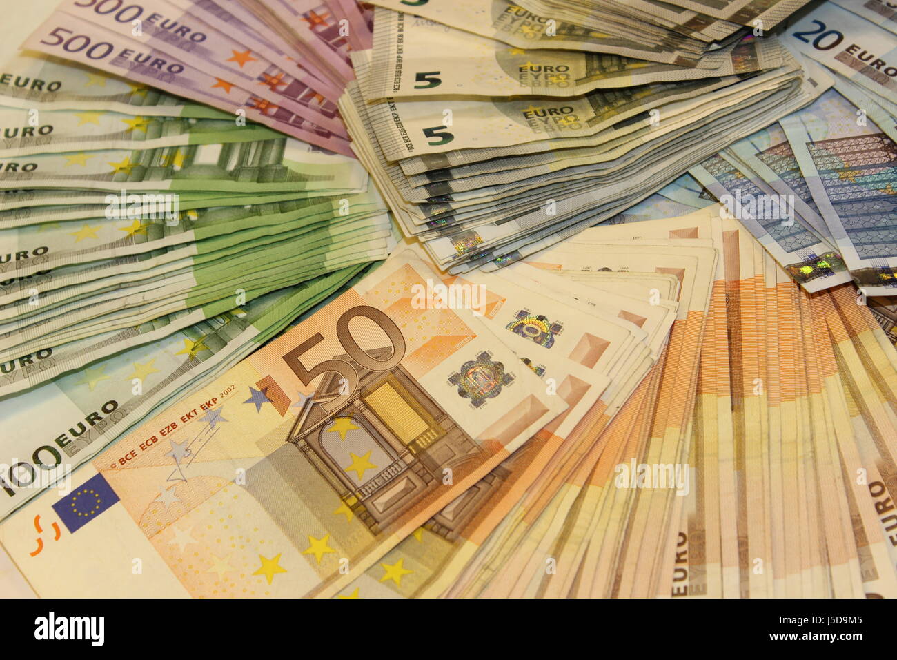 Pile of money Stock Photo - Alamy