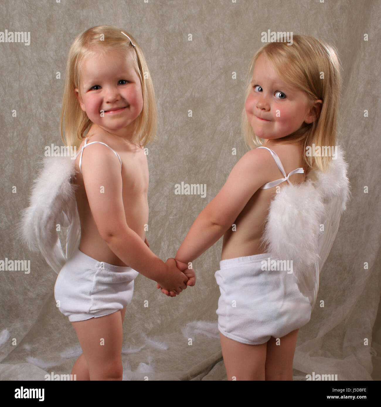 angel angels feathers twins fishing rod child children kids siblings  brothers Stock Photo - Alamy