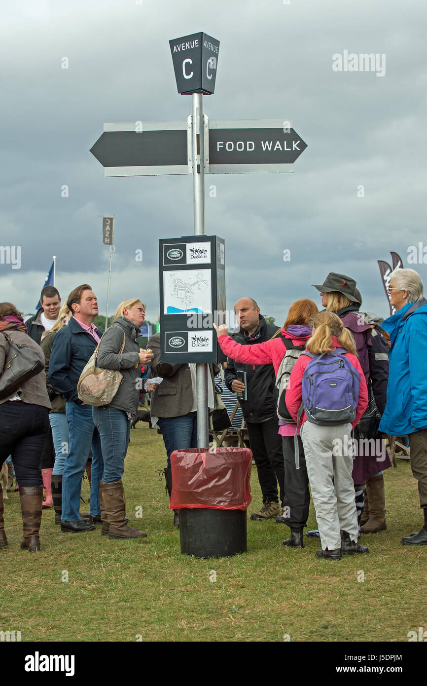 Burghley Horse Trials visitors look for directions in the shopping area. Stock Photo
