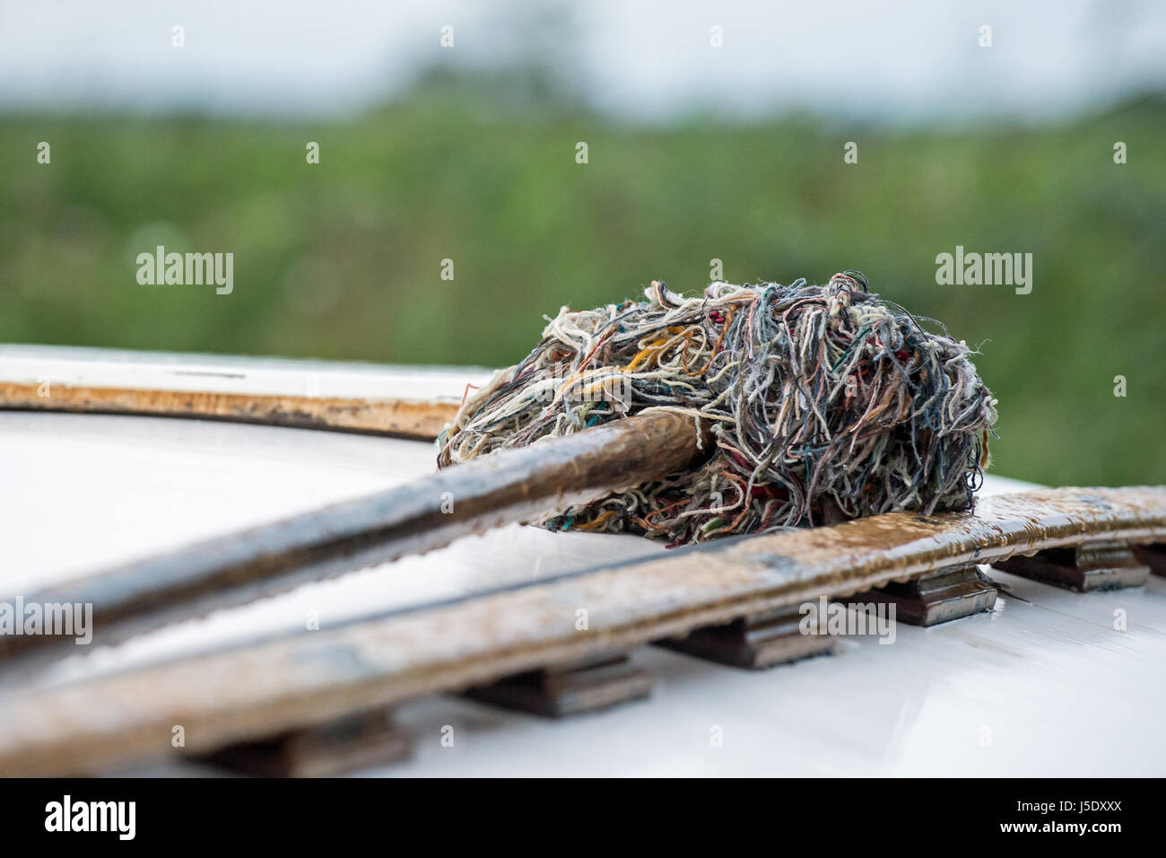 A mop ready for use on the cabin roof of a boat Stock Photo