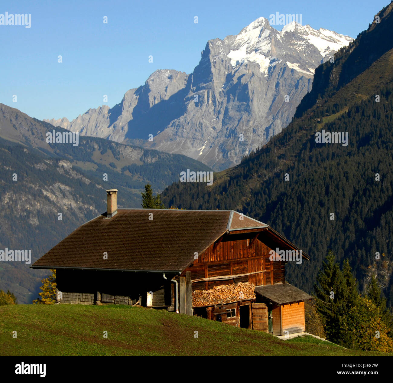 bucolic mountains agriculture farming alps loneliness peace farmhouse seclusion Stock Photo