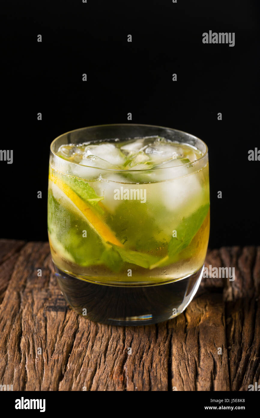 A mojito cocktail sitting on a rustic wooden bar. Stock Photo