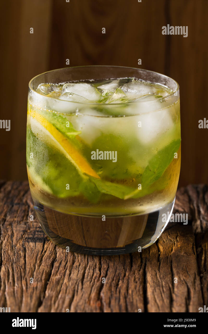 A mojito cocktail sitting on a rustic wooden bar. Stock Photo