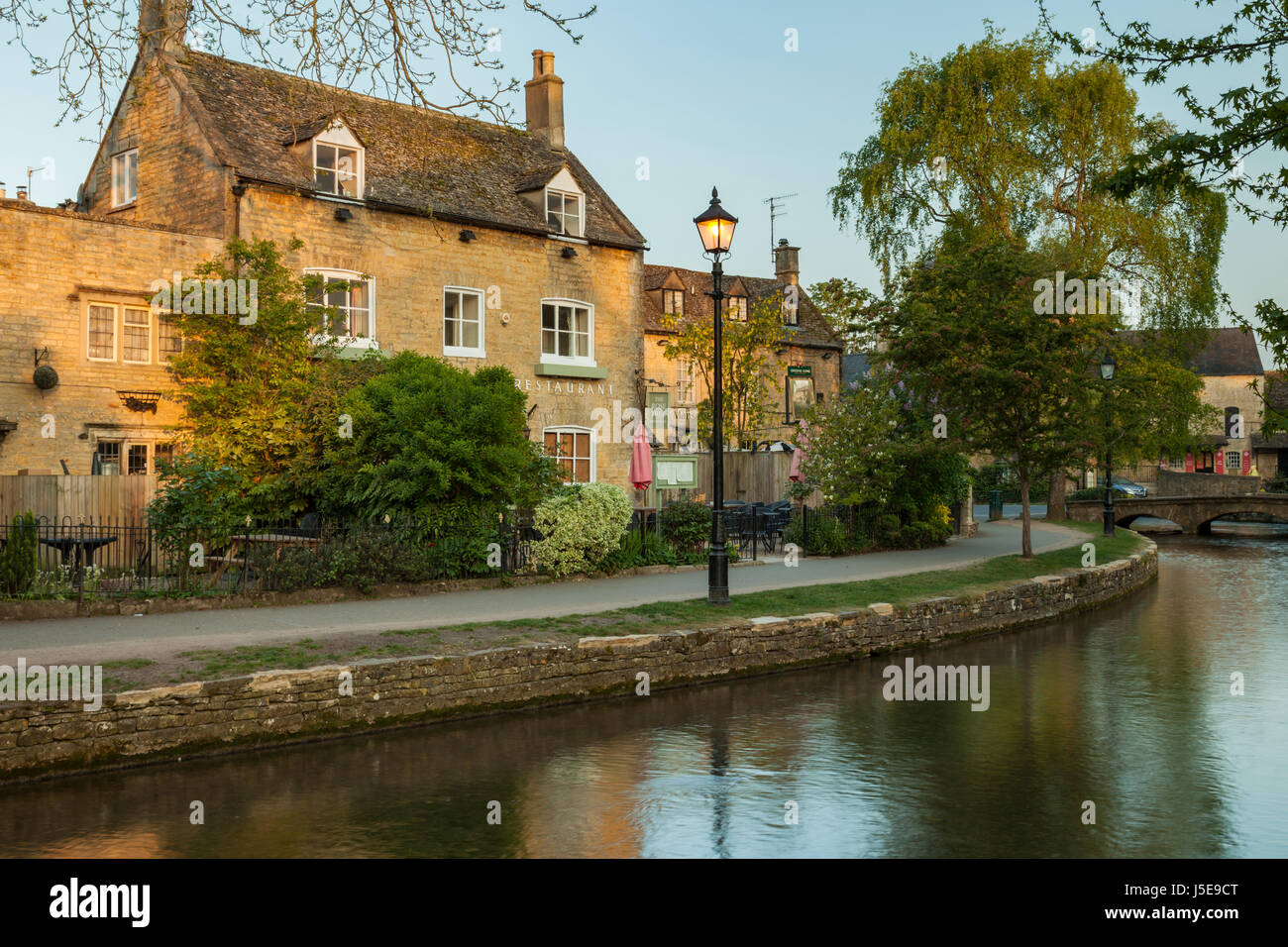 Spring sunrise in the Cotswold village of Bourton-on-the-Water, Gloucestershire, England. Stock Photo