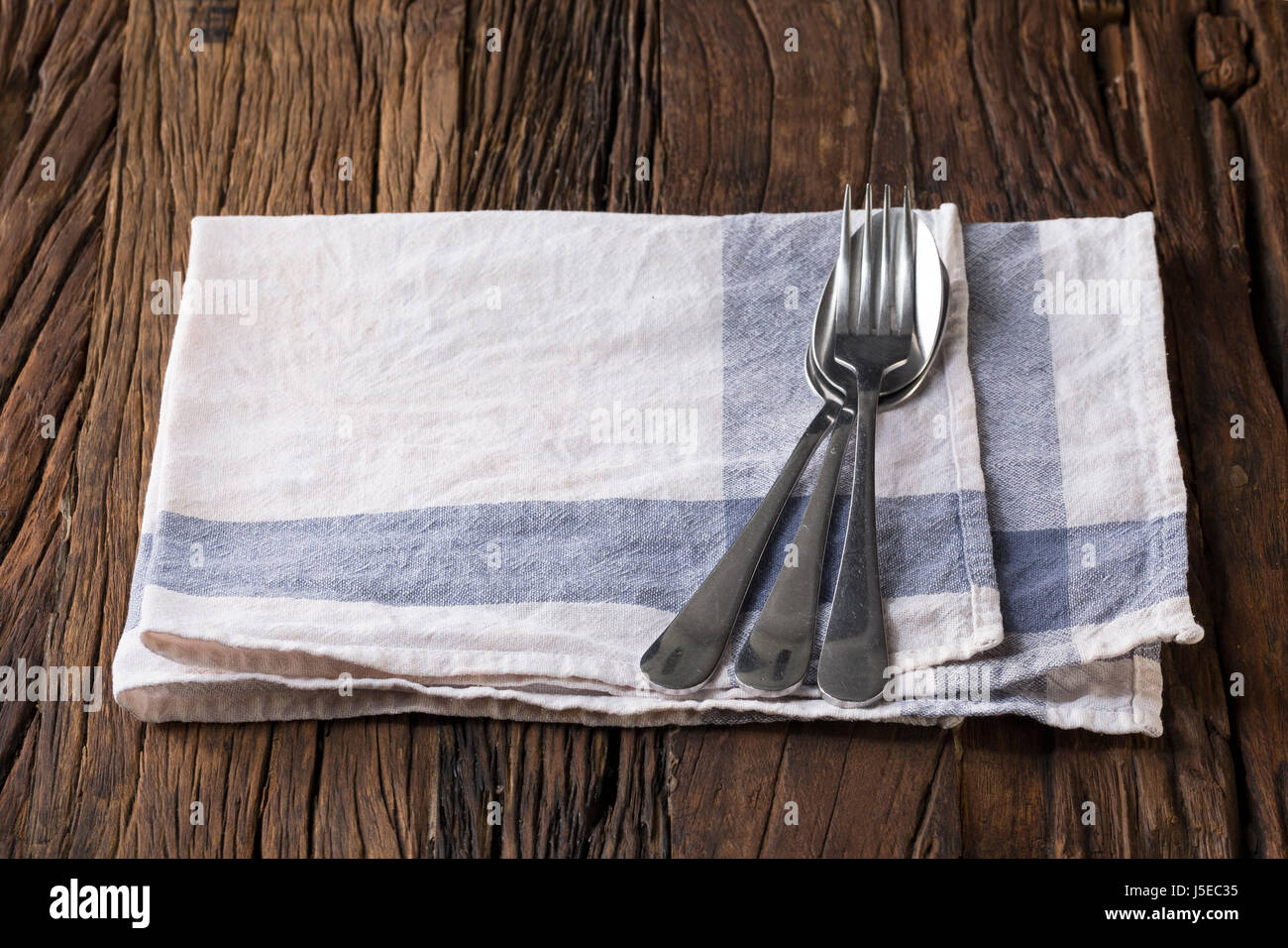 Empty dinner table setting at a rustic kitchen table. Stock Photo