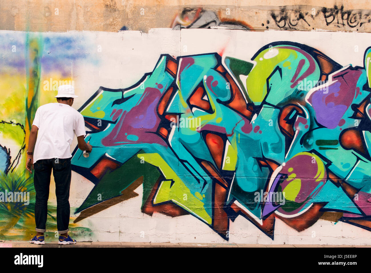 Male teen painting wall spray paint hi-res stock photography and images ...