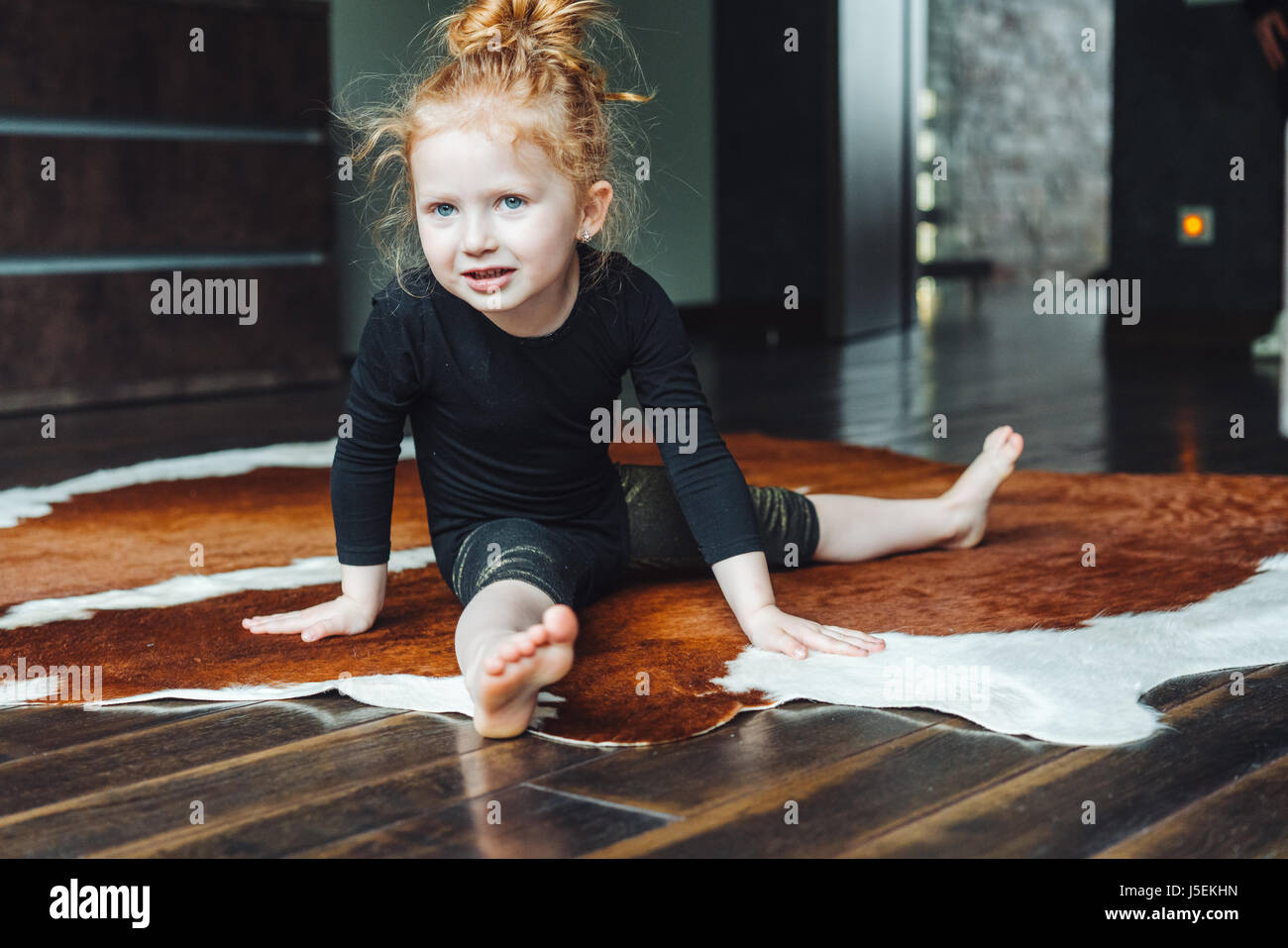 Little girl performs a twine Stock Photo Alamy