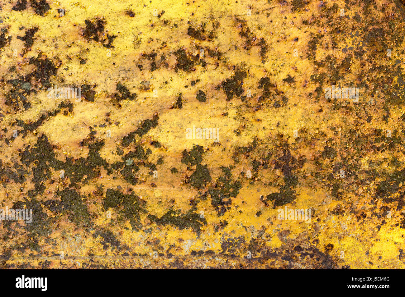 Rusty iron metal surface with yellow paint. Texture and background Stock Photo