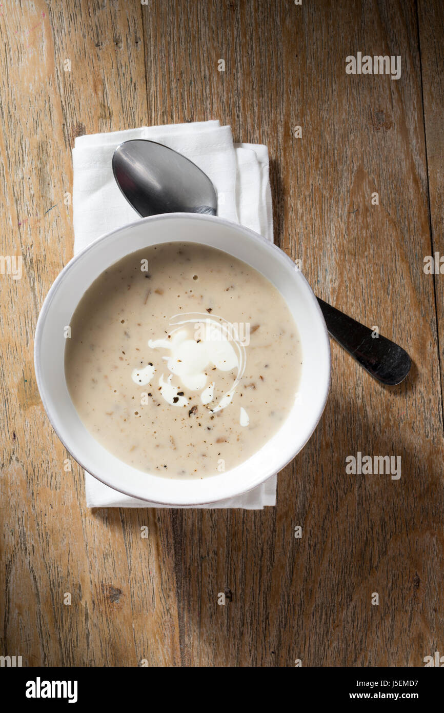 Cream of mushroom soup on a wooden table. Rustic and wholesome food. Stock Photo