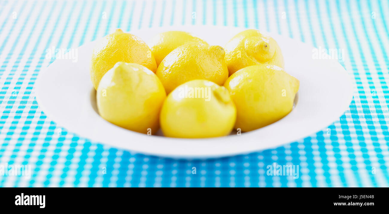 Lemon, Citrus limon, Mass of yellow coloured fruit in white bowl. Stock Photo