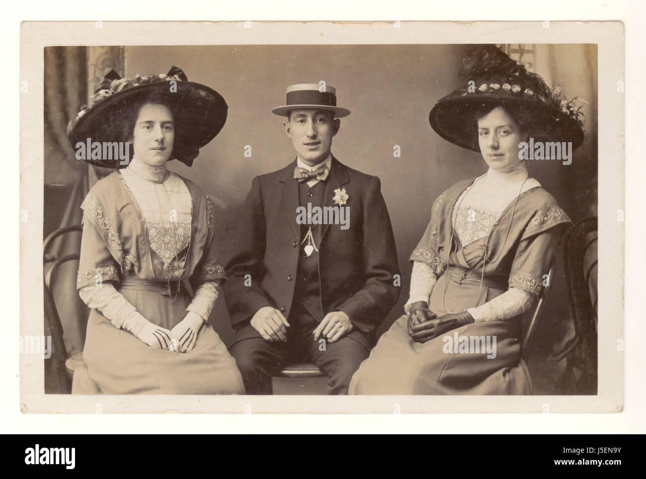 Edwardian postcard of smart women in large hats and young man in a straw boater  hat posing for a studio portrait, England, U.K. circa 1910 Stock Photo -  Alamy