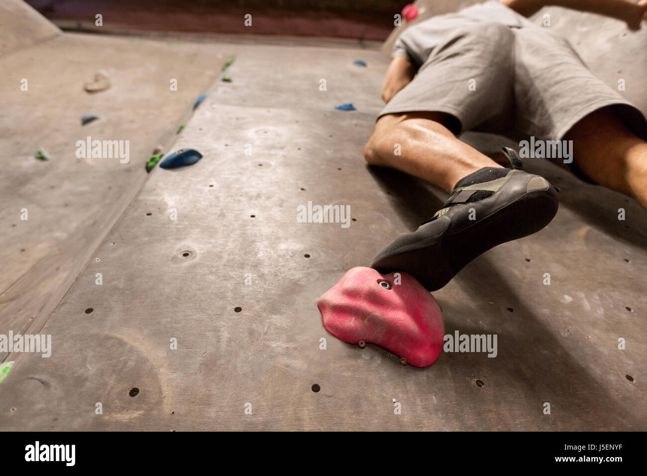 foot of man exercising at indoor climbing gym Stock Photo