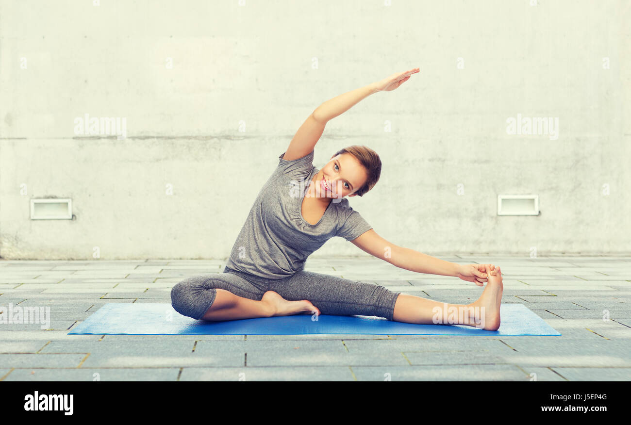 happy woman making yoga and stretching on mat Stock Photo - Alamy