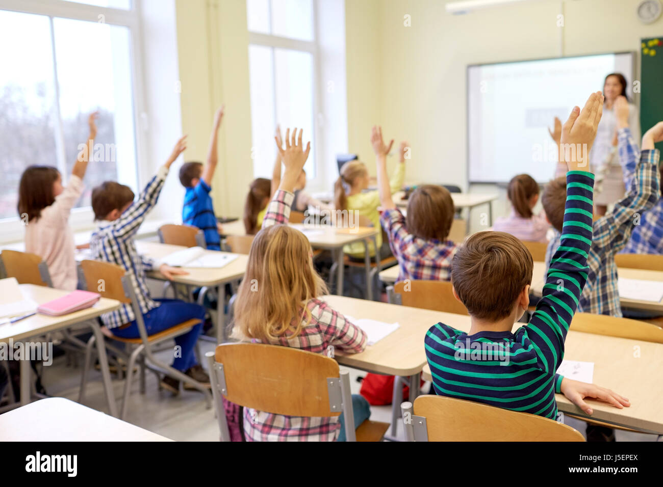 students raising hands