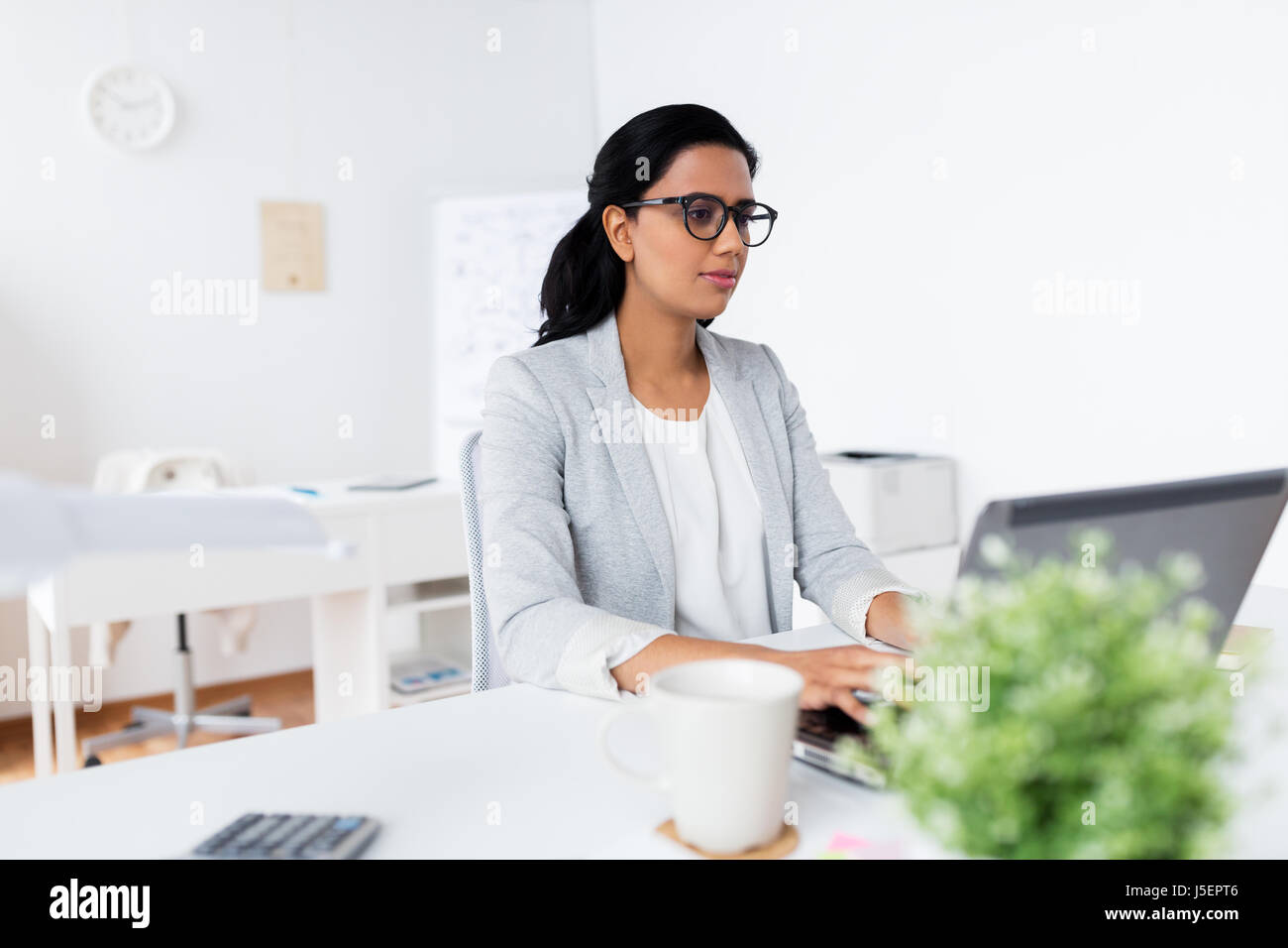 happy businesswoman with laptop at office Stock Photo - Alamy