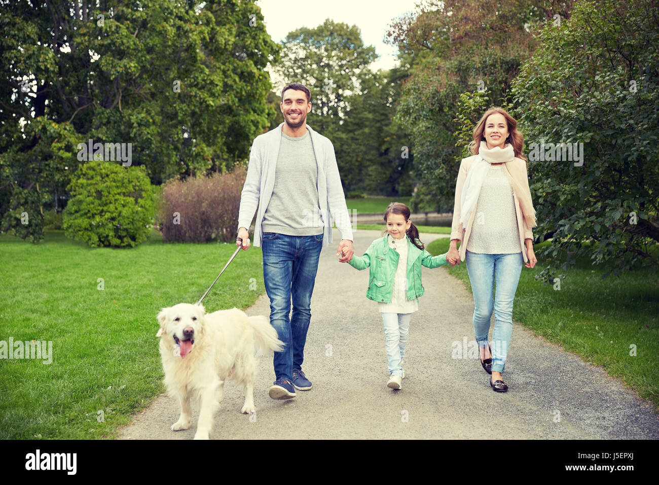 happy family with labrador retriever dog in park Stock Photo Alamy
