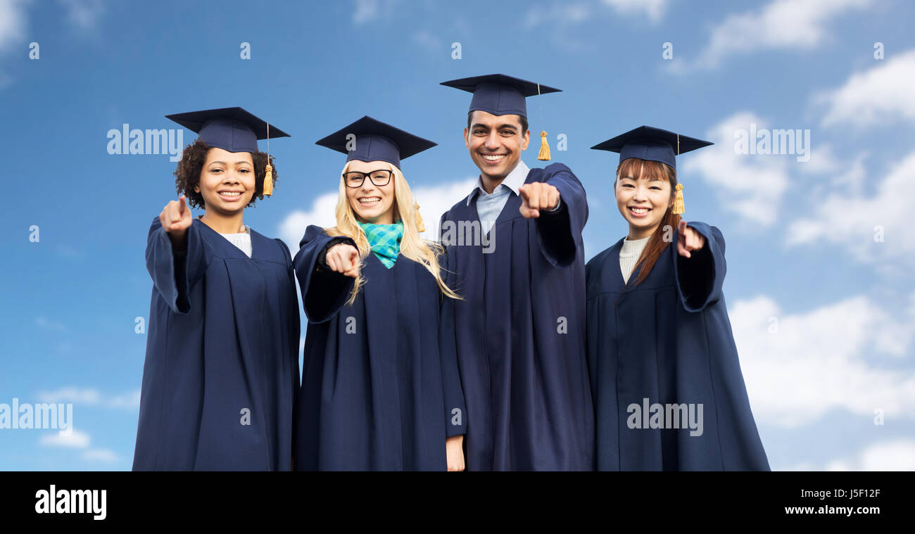 happy students or bachelors pointing finger at you Stock Photo - Alamy