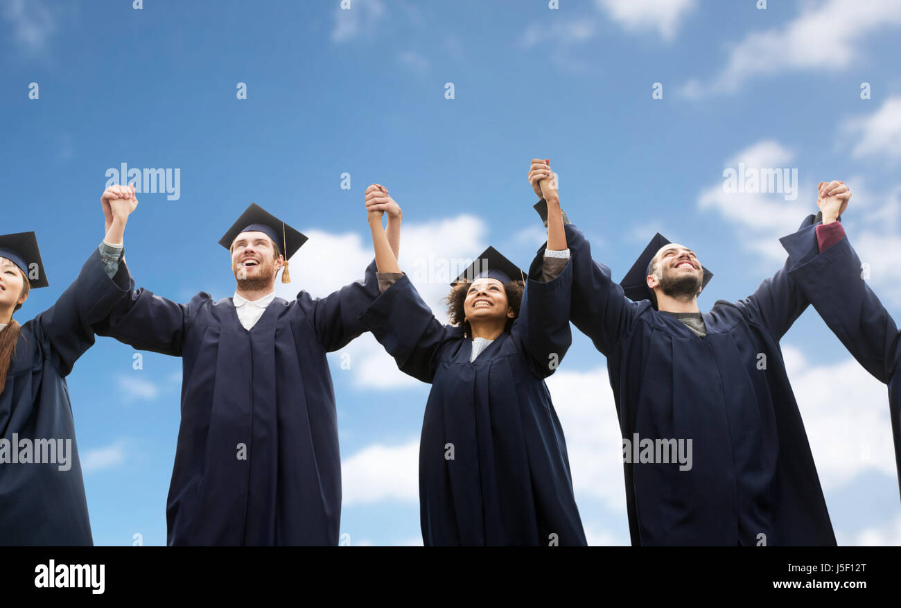 happy students or bachelors celebrating graduation Stock Photo - Alamy