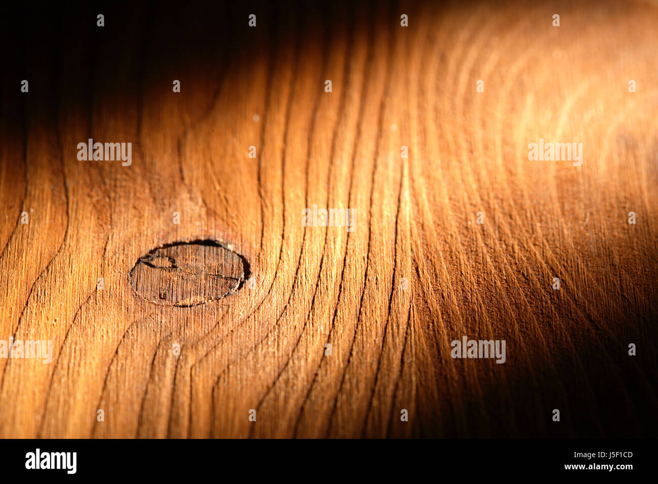 Nice wooden background with knot under beam of light Stock Photo