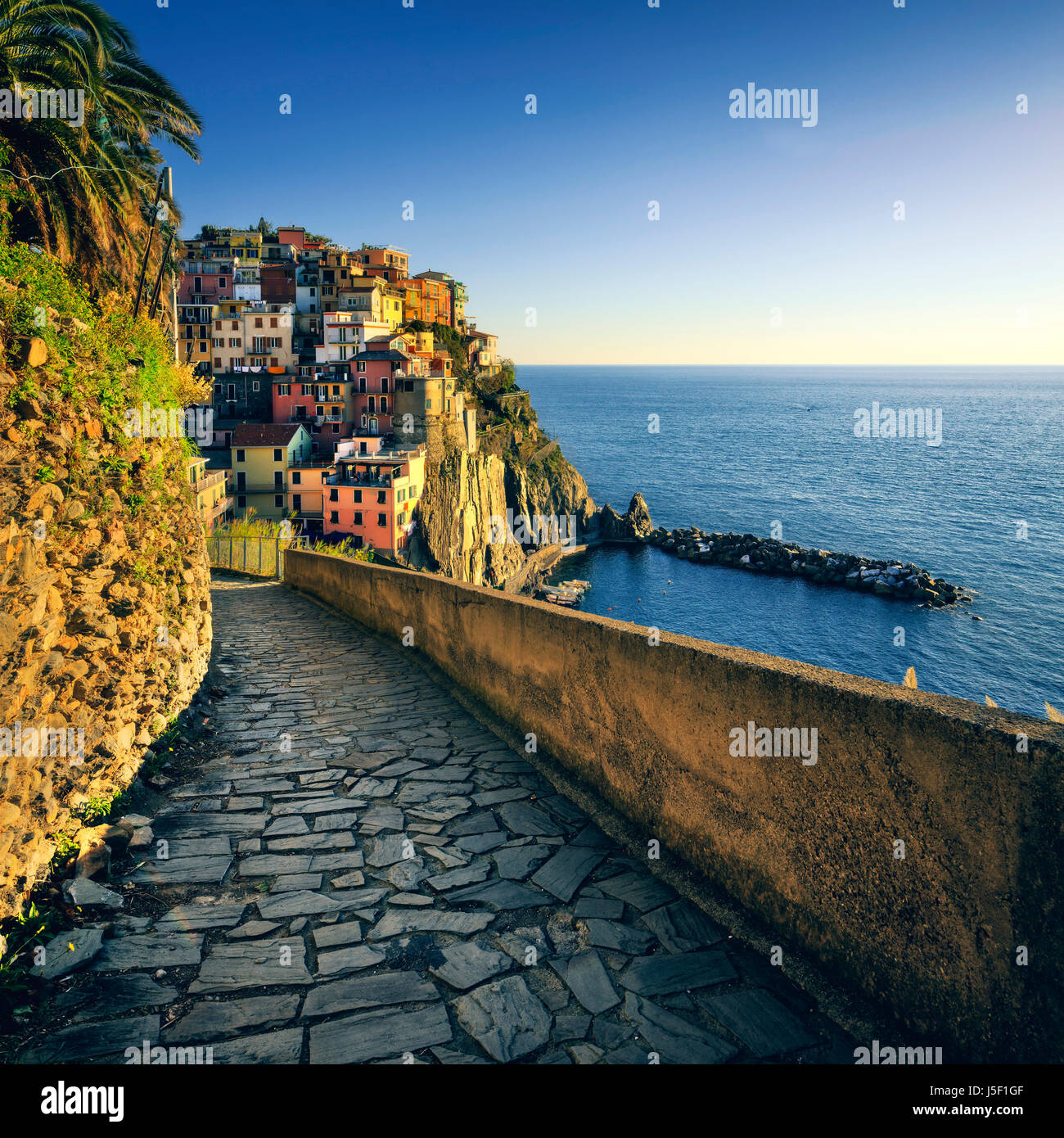 Manarola village, stone trekking trail. Cinque Terre National Park, Liguria Italy Europe. Long Exposure Stock Photo