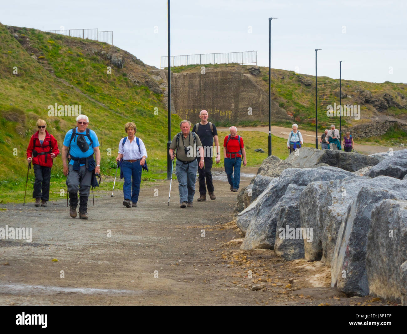 A group of senior people walking on the long-distance Cleveland Way in Skinningrove North Yorkshire Stock Photo