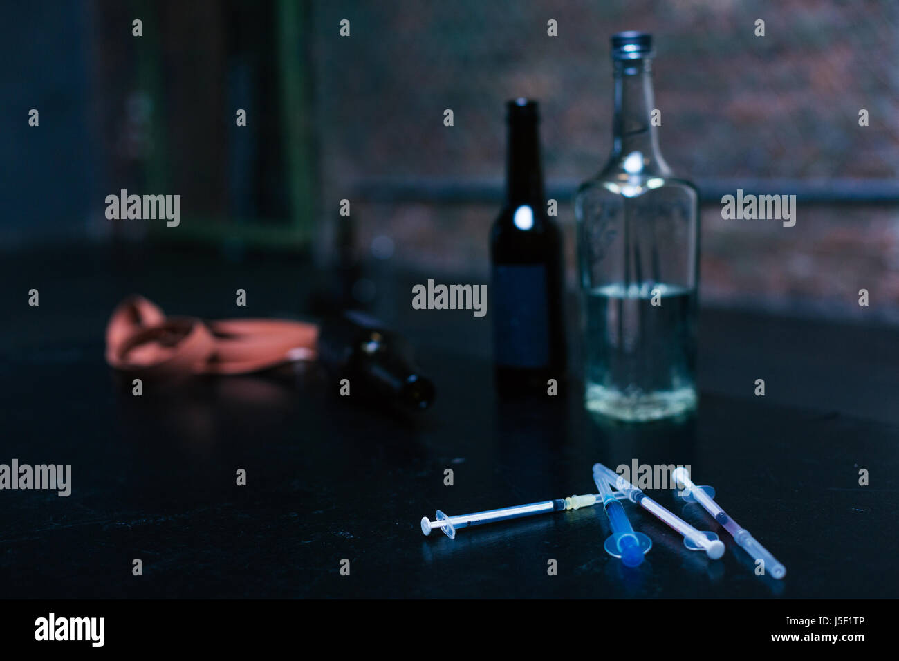 Bottles of alcohol and syringes lying in the garage Stock Photo Alamy