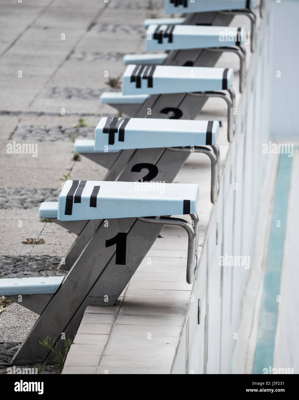 Empty, derelict outdoor swimming pool. Stock Photo