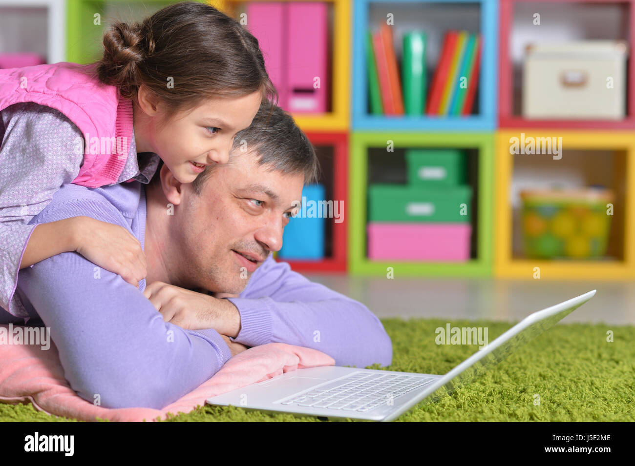 Father with a little daughter using a laptop Stock Photo