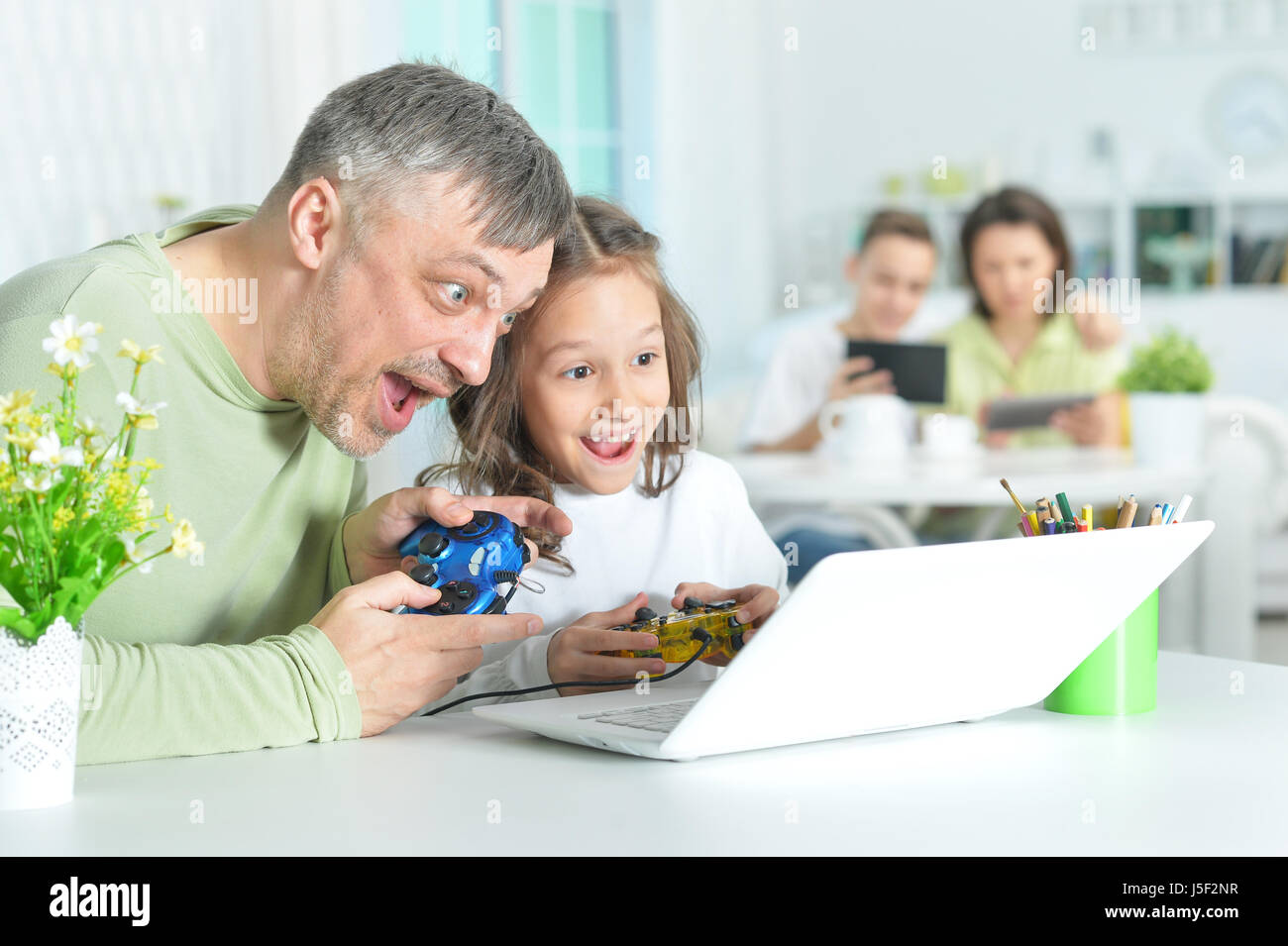 Father with a little daughter using a laptop Stock Photo