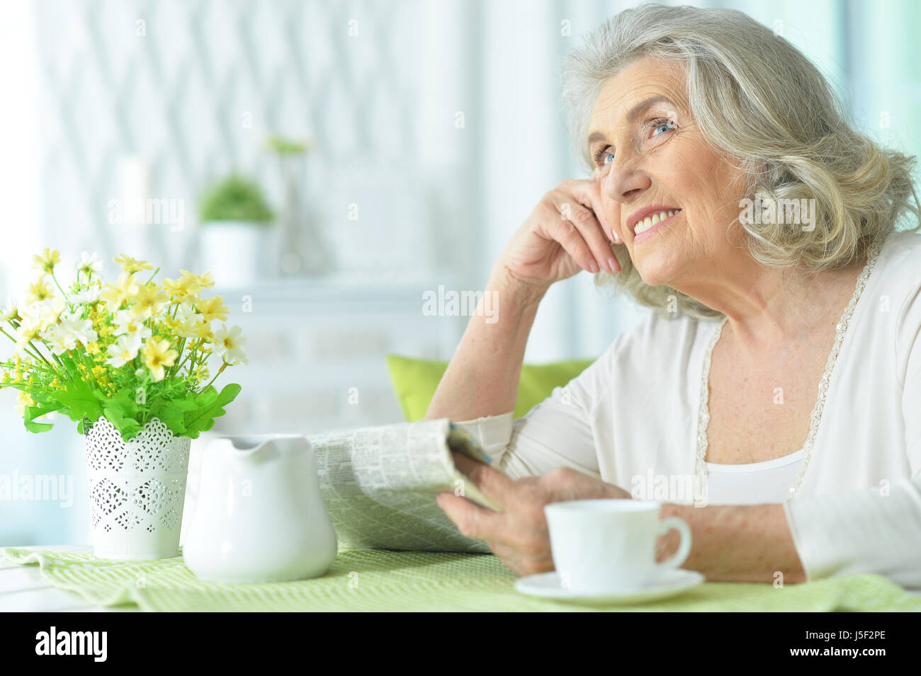 Beautiful elderly woman drinking tea Stock Photo - Alamy