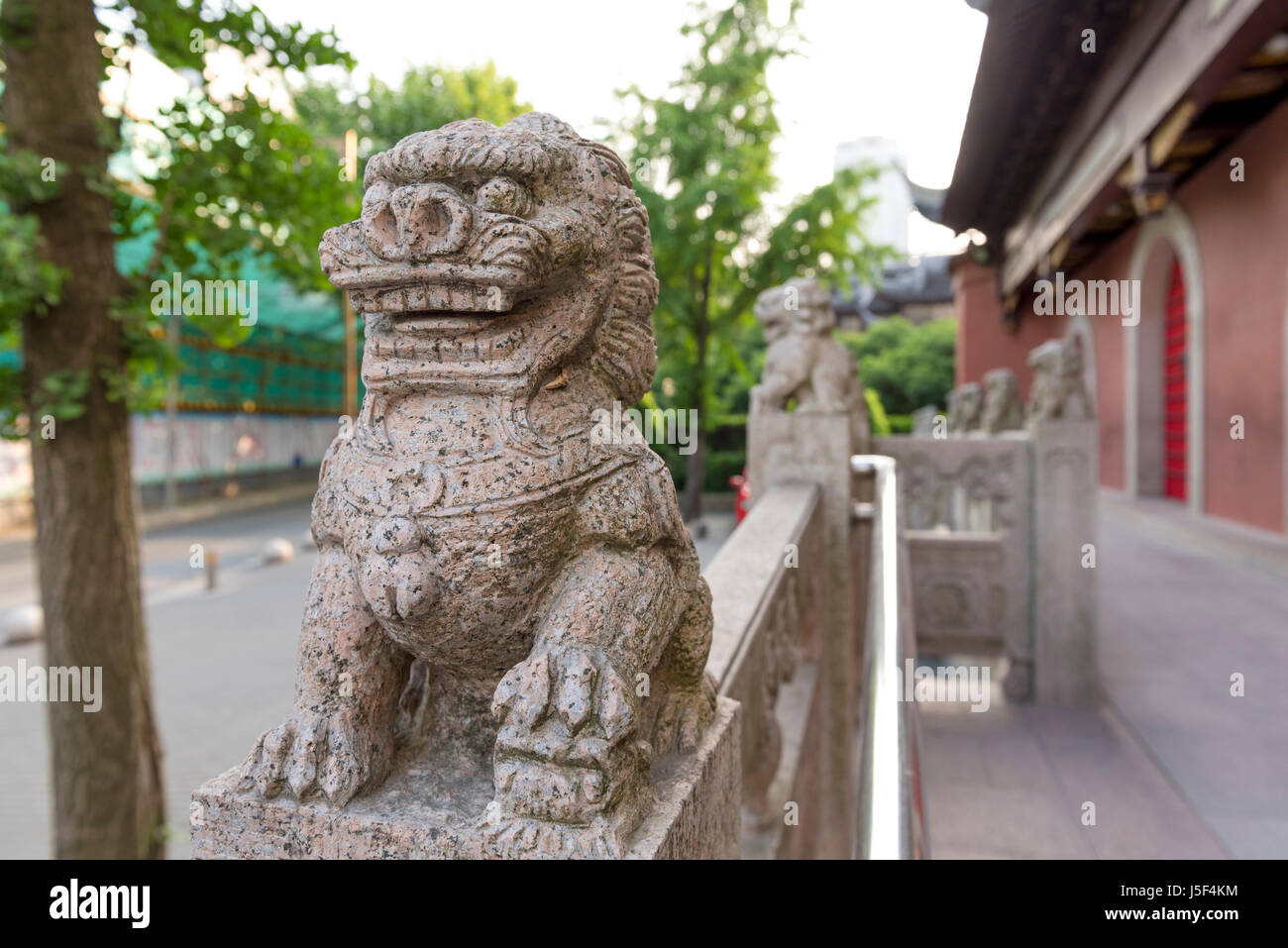 Lion guardian stone statues protecting a Buddhist temple in Shanghai, China Stock Photo