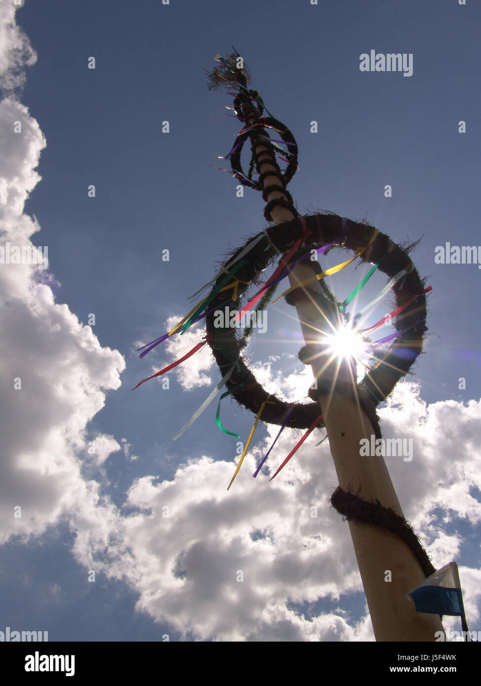 trunk sunbeams diagonal custom May festoons traditions chaplet maypole sky-high Stock Photo