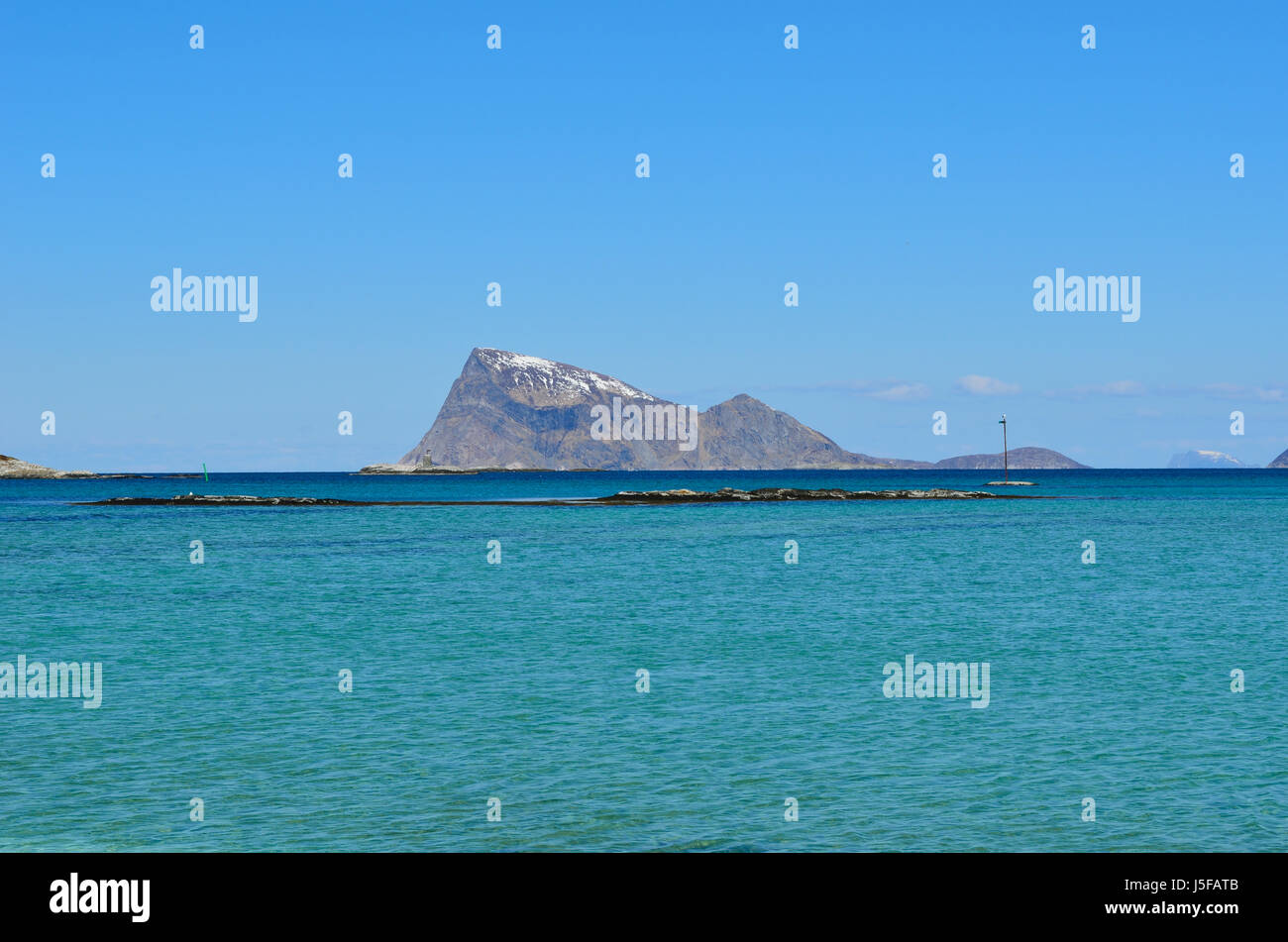 majestic white springtime beach with snowy mountain islands in sea on ...