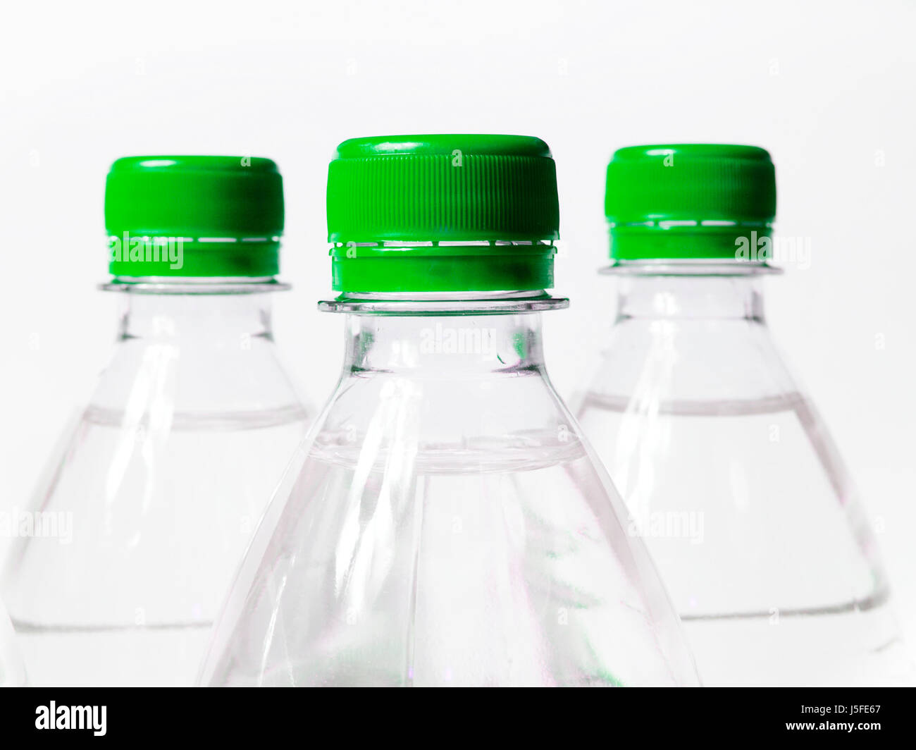 green plastic synthetic material container bottles lid water schraubverschluss Stock Photo