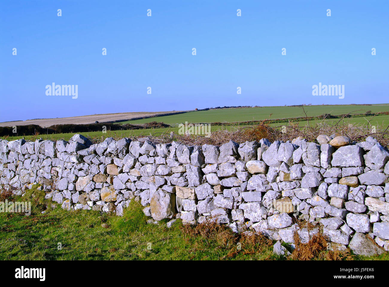 hill horizon stone agriculture farming field grasses wall steppe fence ...