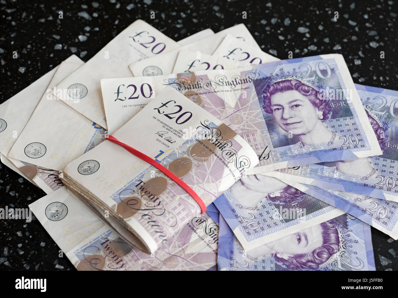 Close up of a pile of English cash money £20 banknote banknotes twenty pound notes savings bundle England UK United Kingdom GB Great Britain Stock Photo