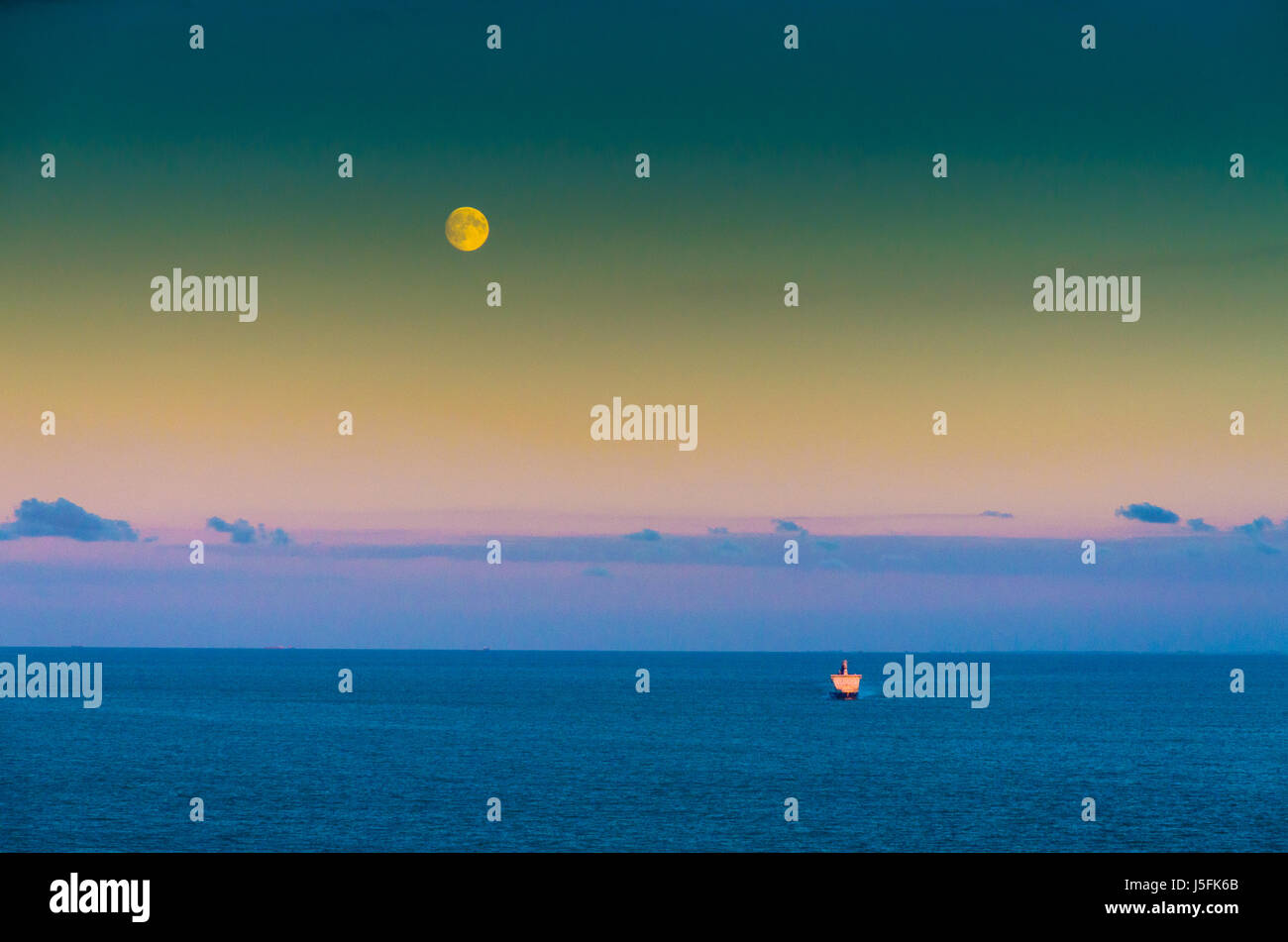 Lonely Ship in the English Channel under a full mooon Stock Photo