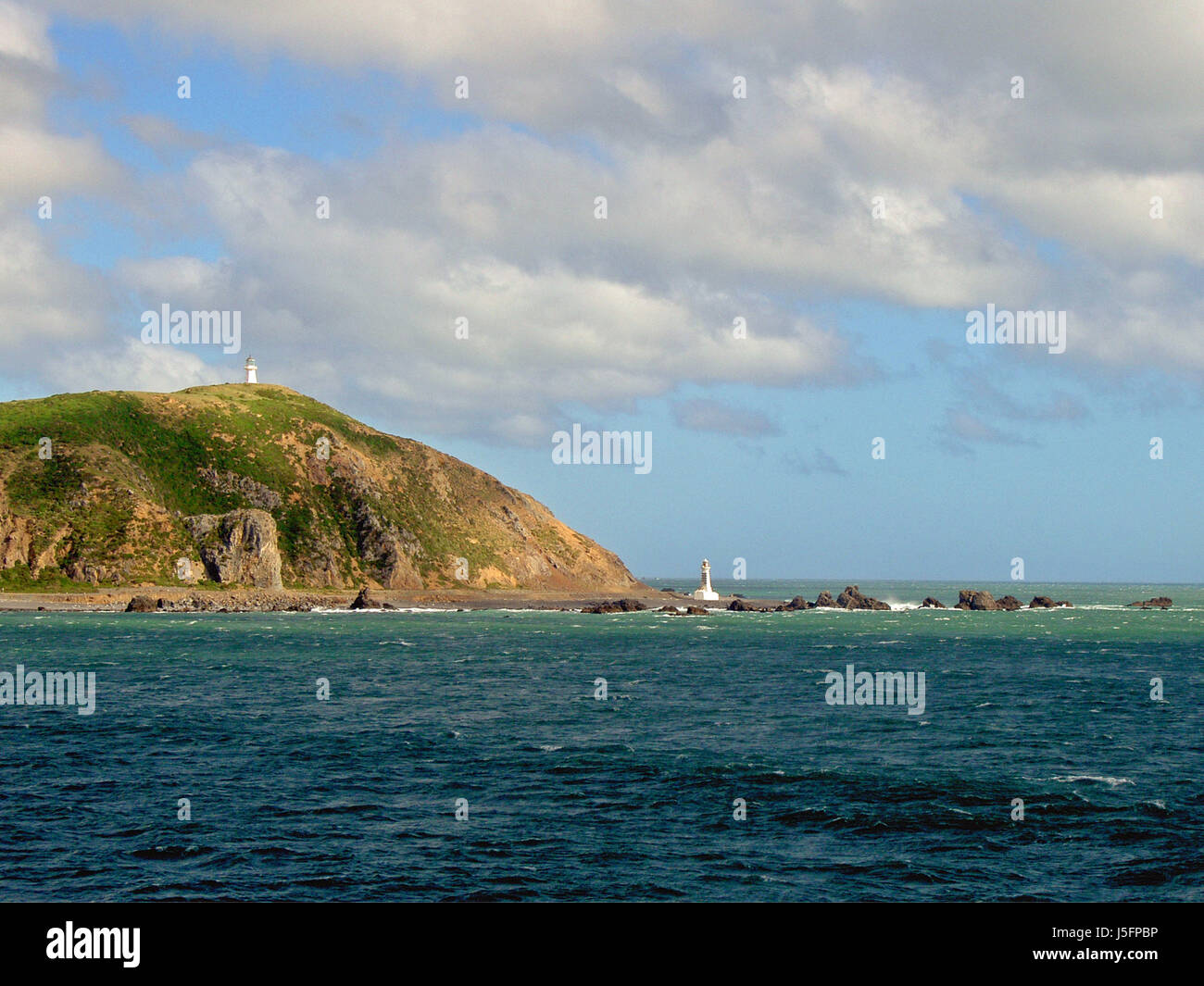 tower towers coast new zealand salt water sea ocean water lighthouse two clouds Stock Photo