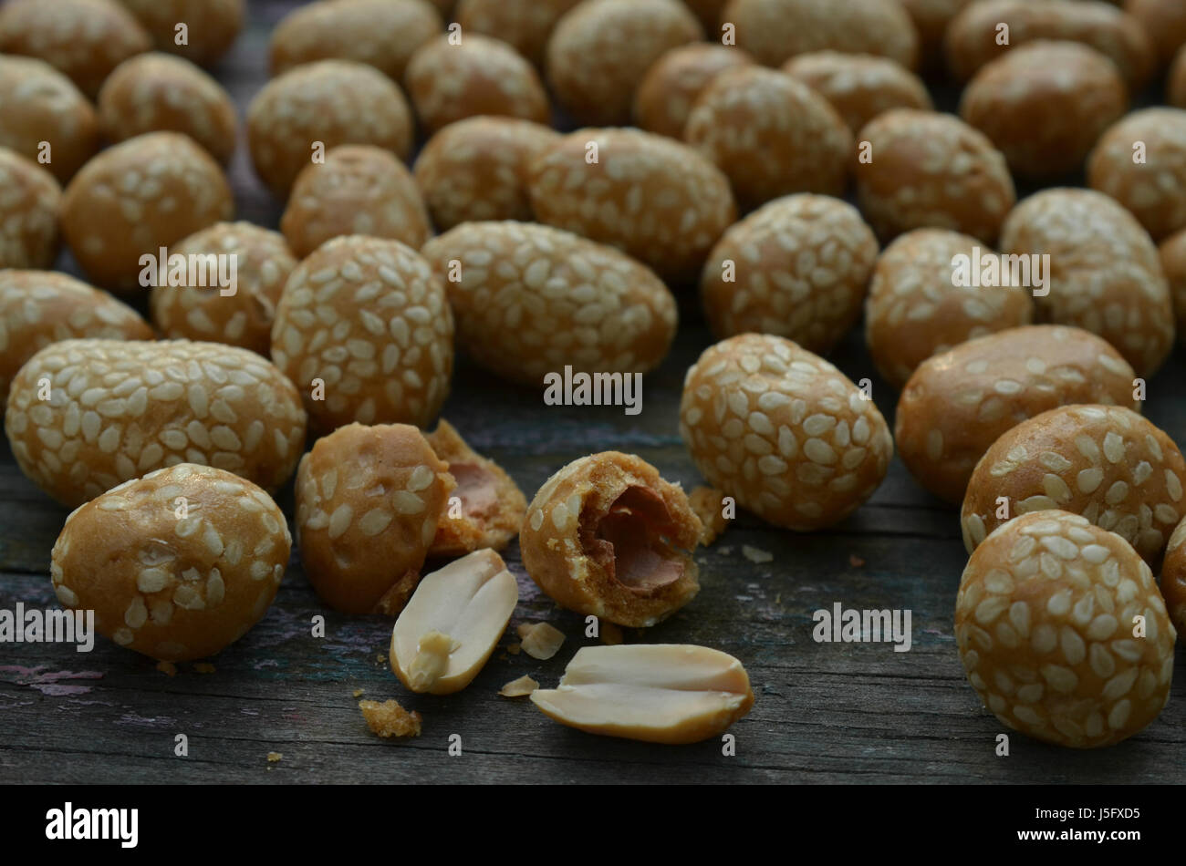 sesame seed covered candied peanuts Stock Photo Alamy