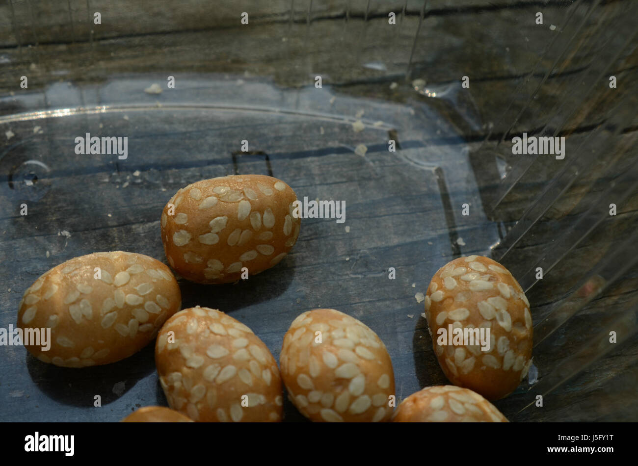 sesame seed covered candied peanuts Stock Photo Alamy