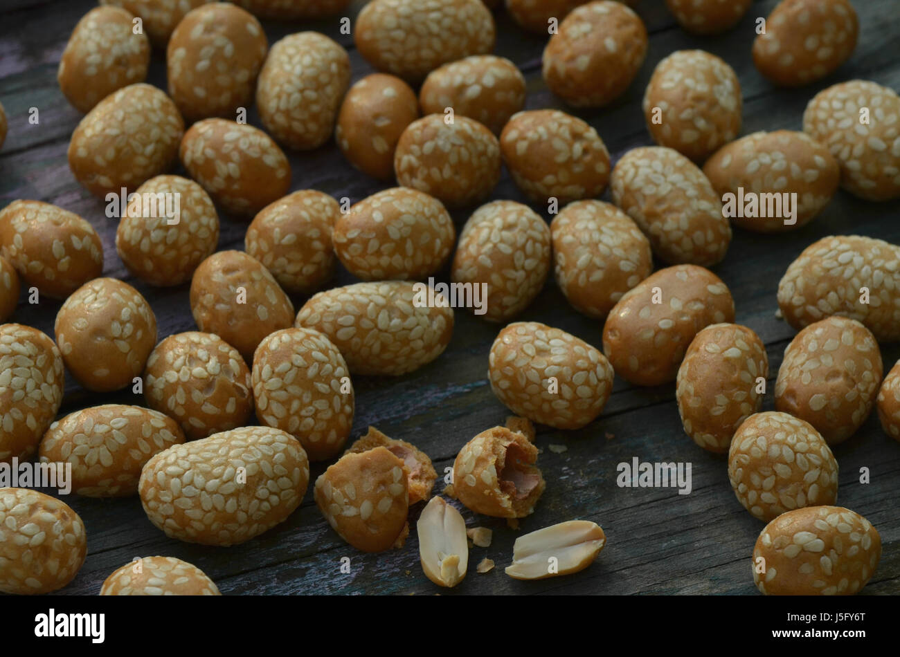sesame seed covered candied peanuts Stock Photo Alamy