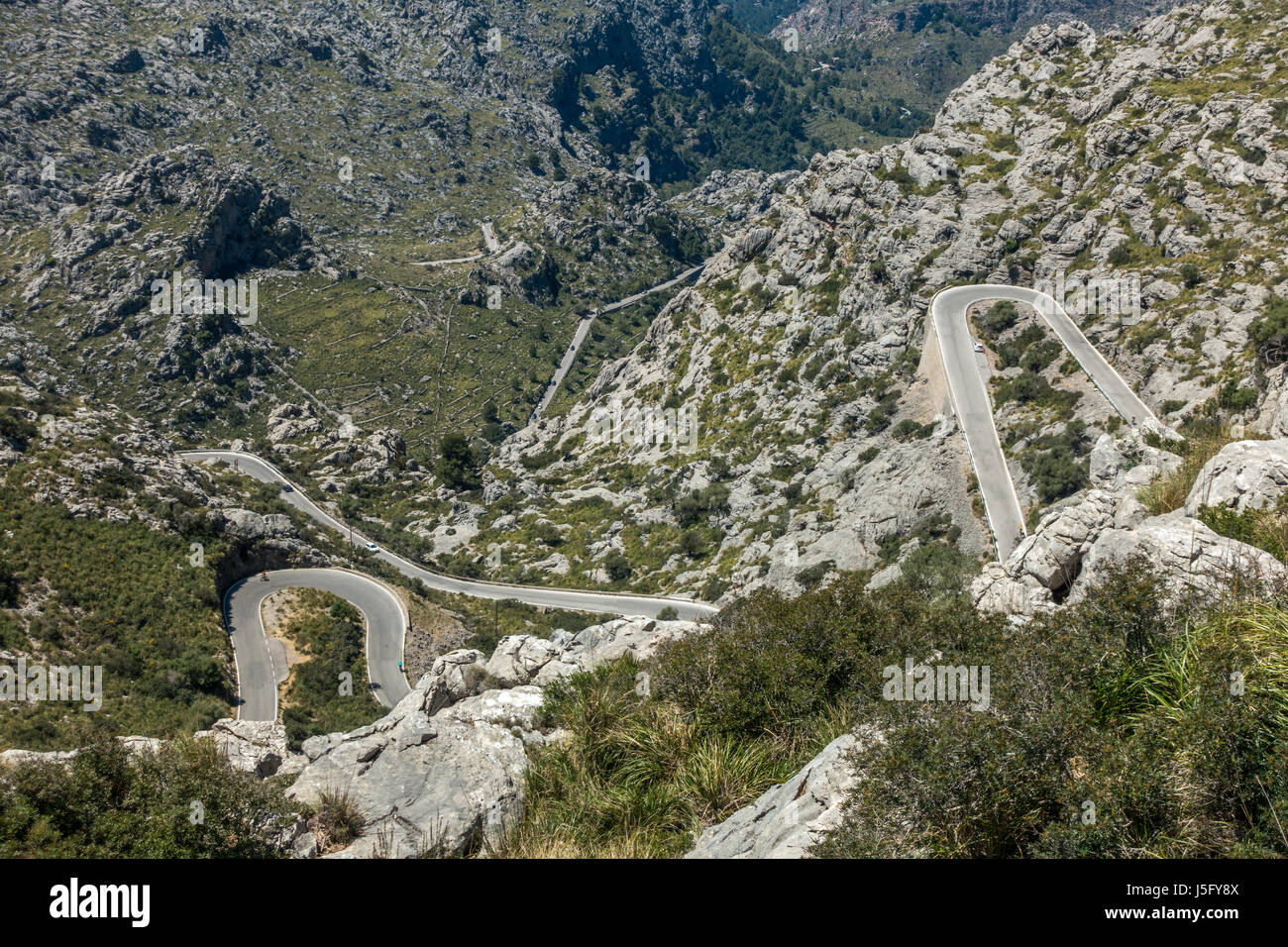 Cyclists on the famous winding road down to the coastal village of Sa Calobra, Mallorca, Majorca, Balearic Islands, Spain Stock Photo