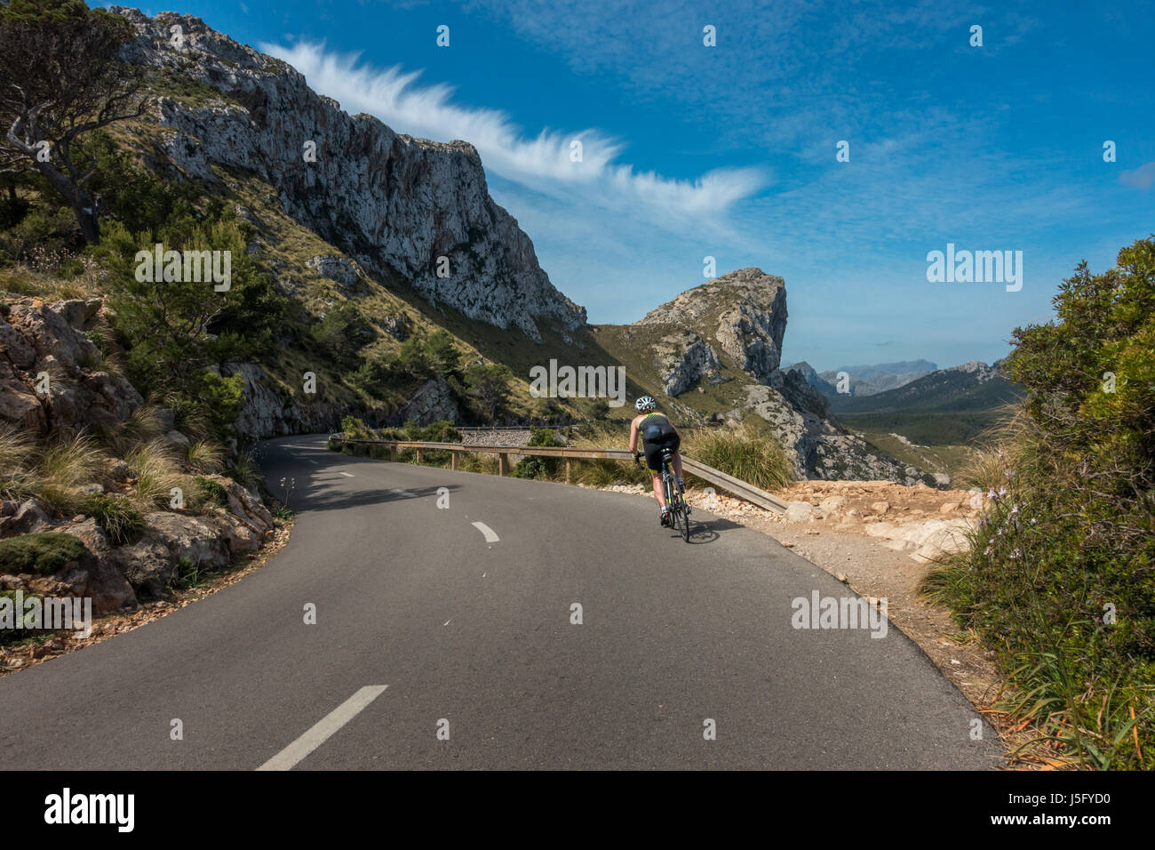 The beautiful scenic roads of the Cap de Formentor with female cyclist person, Mallorca, Majorca, Balearic Islands, Spain Stock Photo