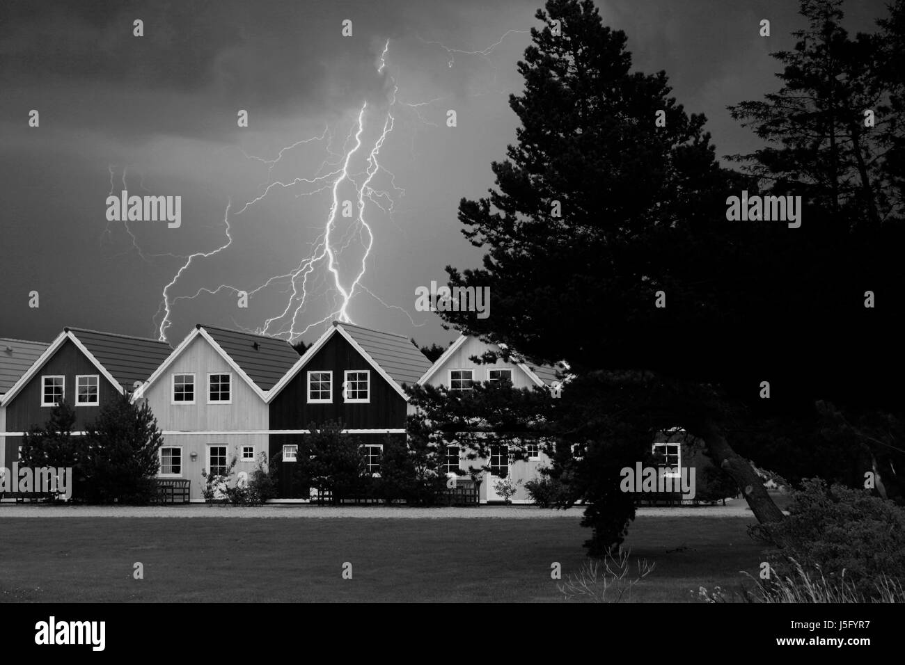 houses with thunderstorms Stock Photo